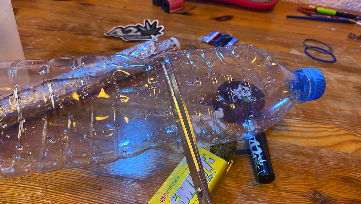 To make a gravity bong, cut the upper part of a plastic bottle. To make a gravity bong, cut the upper part of a plastic bottle.
