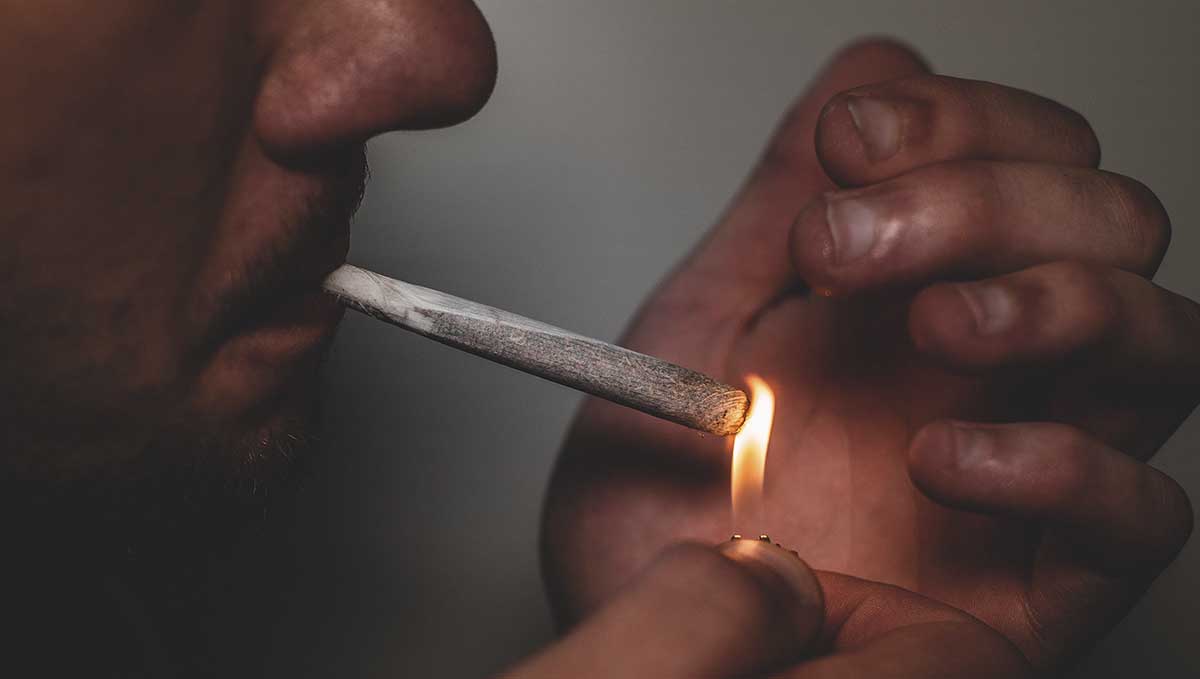 Spliff Definition – What Is a Spliff? A closeup of a man's face as he lights up a cannabis cigarette Spliff Definition – What Is a Spliff? A closeup of a man's face as he lights up a cannabis cigarette