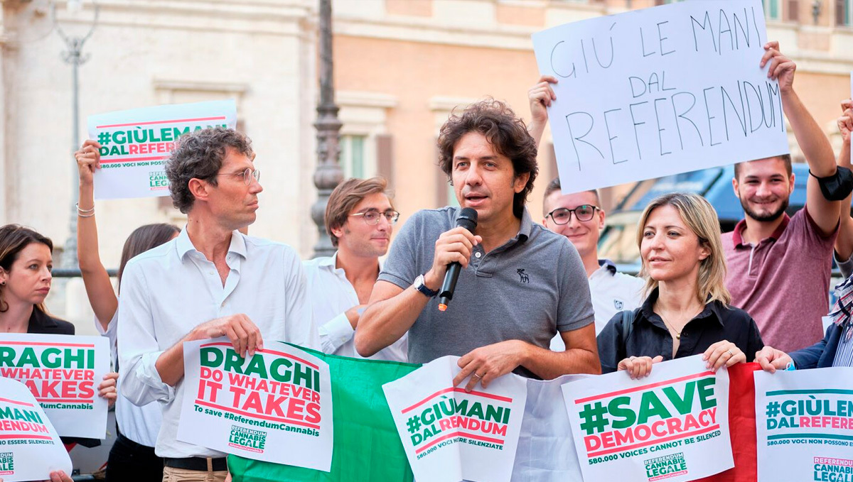 Italy: Court Stalls Referendum to Legalize Weed Growing. Protesters holding signs in favor of protecting democracy
