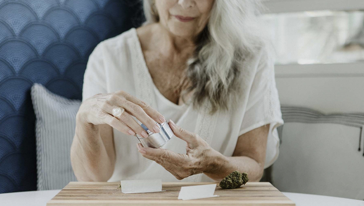 Cannabis Is Becoming More Popular Among the Elderly: An elderly woman is grinding cannabis buds and is about to roll a marijuana cigarette Cannabis Is Becoming More Popular Among the Elderly: An elderly woman is grinding cannabis buds and is about to roll a marijuana cigarette