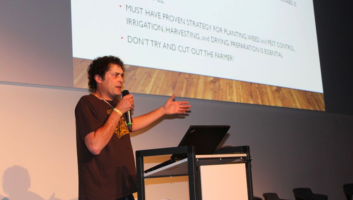 Sasha giving a speech at a conference. Sasha giving a speech at a conference.