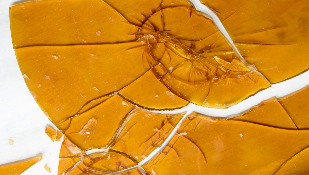 Cannabis Shatter: What Is It, How To Make And Smoke THC & CBD Hash Oil: A sheet of shatter lying on a white surface and broken into several pieces Cannabis Shatter: What Is It, How To Make And Smoke THC & CBD Hash Oil: A sheet of shatter lying on a white surface and broken into several pieces
