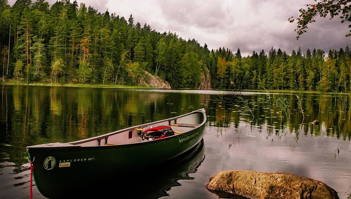 Weed in Finland: Cannabis Legal Status Guide: A lake with a boat and a forest in the background Weed in Finland: Cannabis Legal Status Guide: A lake with a boat and a forest in the background