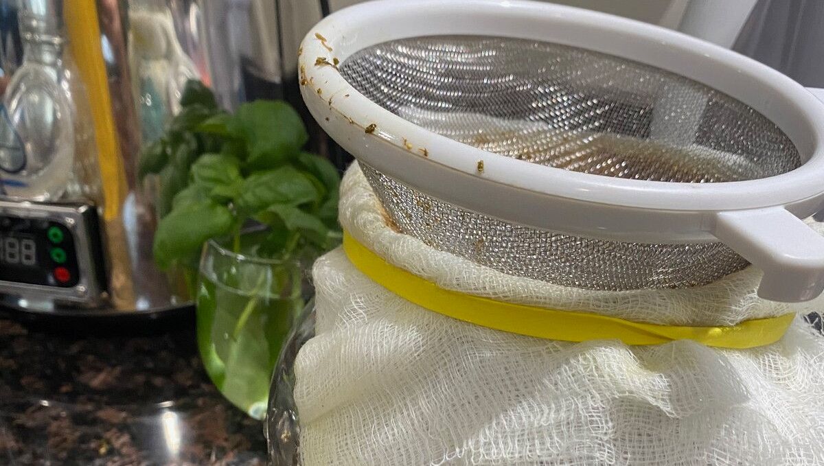 What is Rick Simpson Oil (RSO): Does It Work? A filtering system consysting of a metal strainer and a cheesecloth