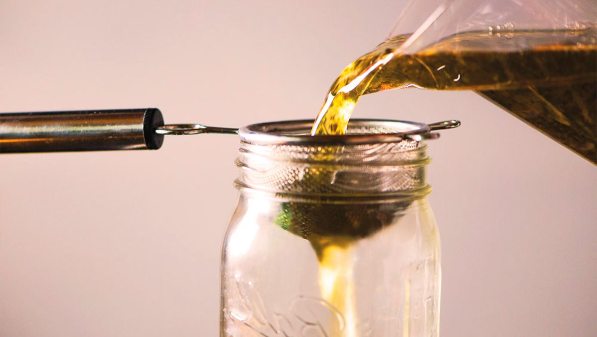 THC Syrup Explained: What Is THC Lean & How to Make It: Cannabis-infused oil filtered through a metal strainer THC Syrup Explained: What Is THC Lean & How to Make It: Cannabis-infused oil filtered through a metal strainer